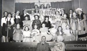 Front of stage Mrs. Hans Hamilton, writer and producer, with Sam McDonald who provided music for Guides and Brownies' pantomimes.