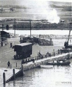 Yarmouth Quay with the Dump seen burning in background